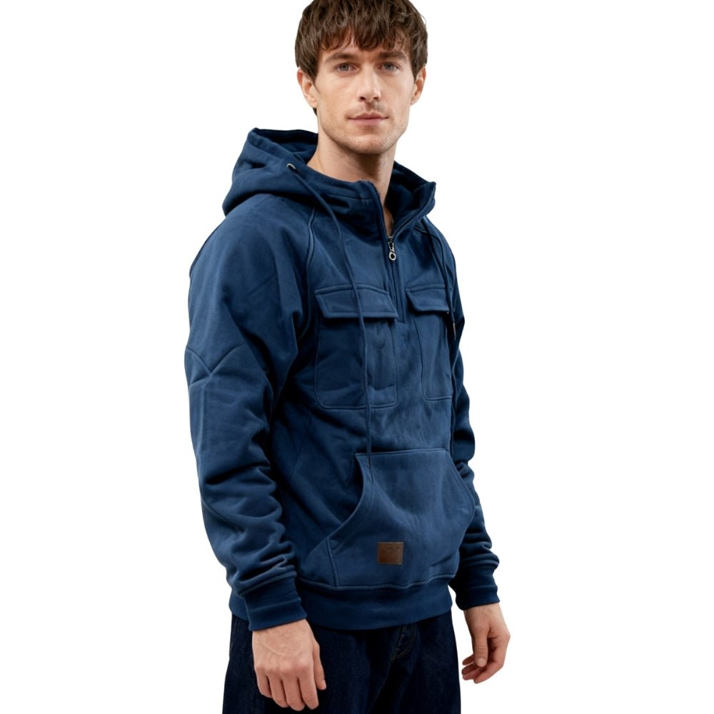 Angled side view of the men's slate blue Dominic half-zip hoodie, showing the structured hood and kangaroo pocket.
