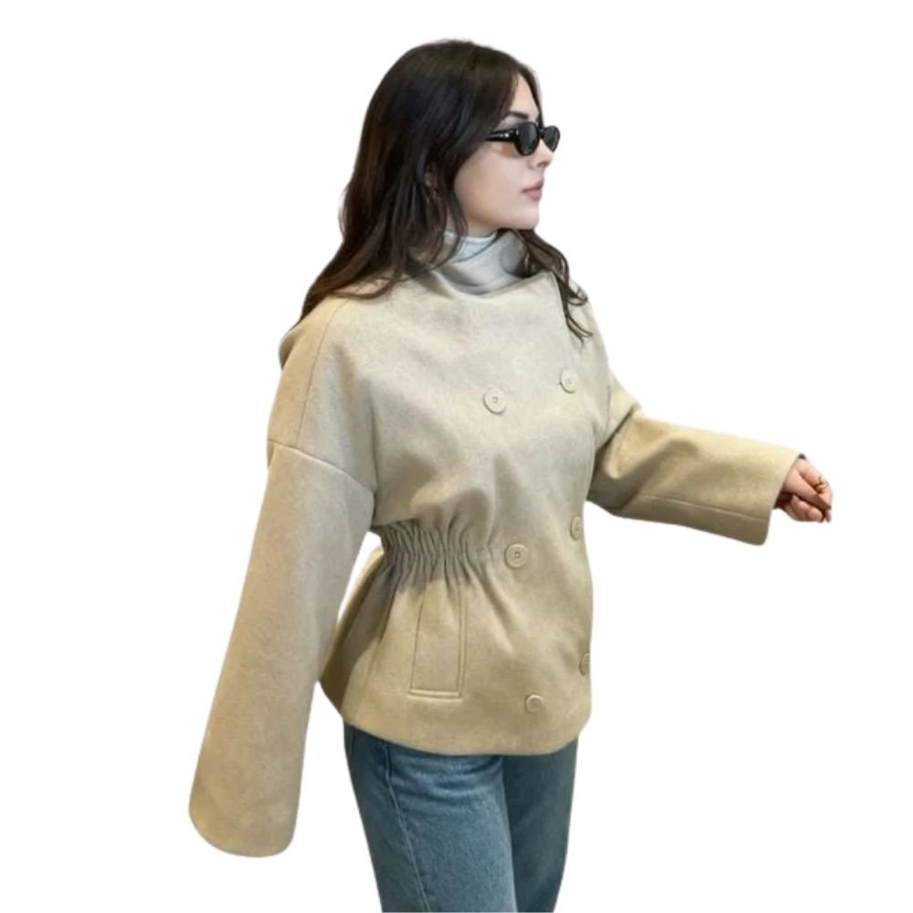 Model wearing the Kouvr oversized oatmeal wool jacket with blue jeans and a brown shoulder bag