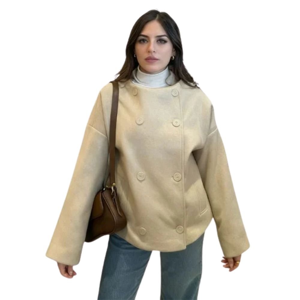 Model wearing the Kouvr oversized oatmeal wool jacket with blue jeans and a brown shoulder bag