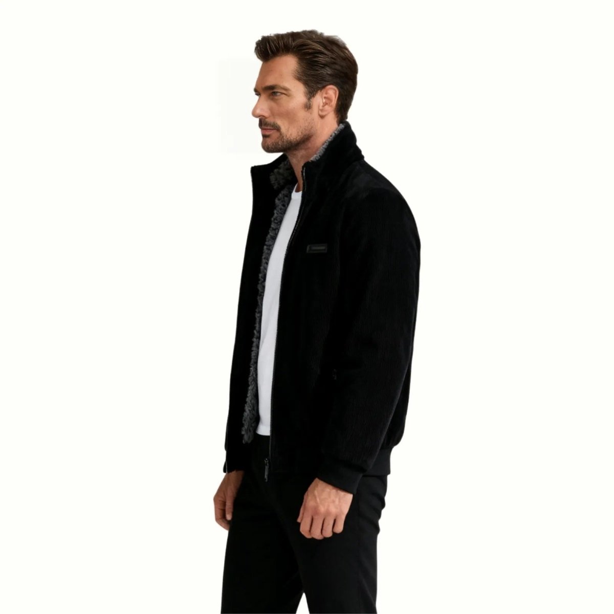 Side profile view of a man in the Kouvr Nick black corduroy shearling jacket, highlighting the fit and stand collar.