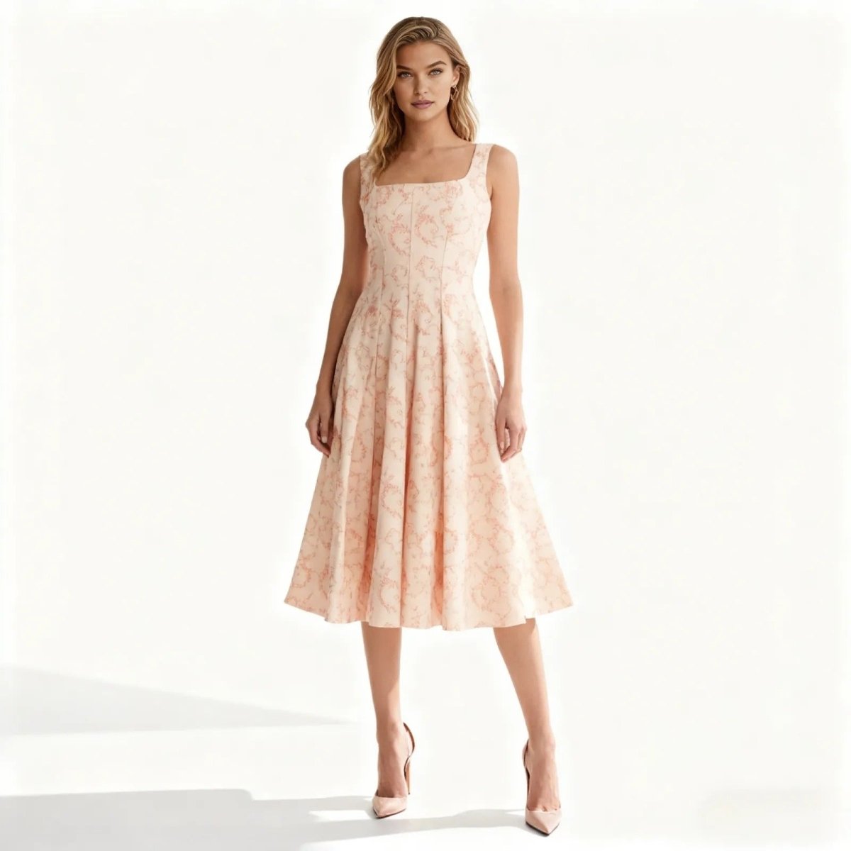 Woman wearing a light pink floral dress on a white background