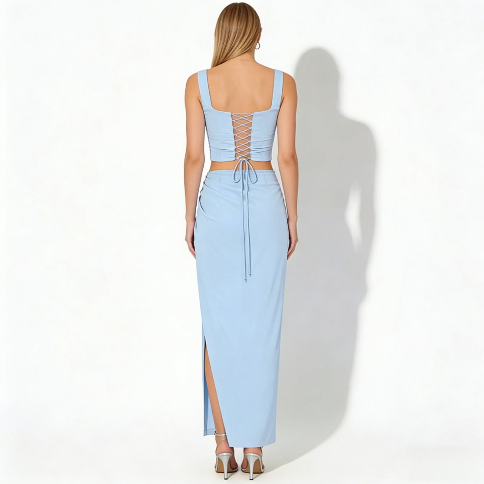 Back view of the Kouvr Rona set in light blue, highlighting the adjustable lace-up detail on the corset crop top.