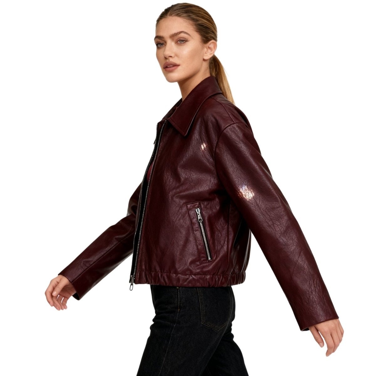 Woman wearing a Burgundy Kouvr leather jacket on a white background