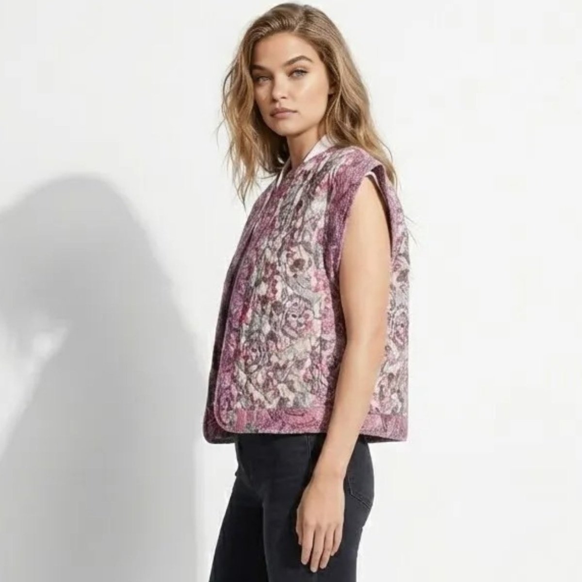 Side view of a model in the Kouvr Fashion cap sleeve quilted vest, showcasing the flattering silhouette and intricate jacquard pattern.