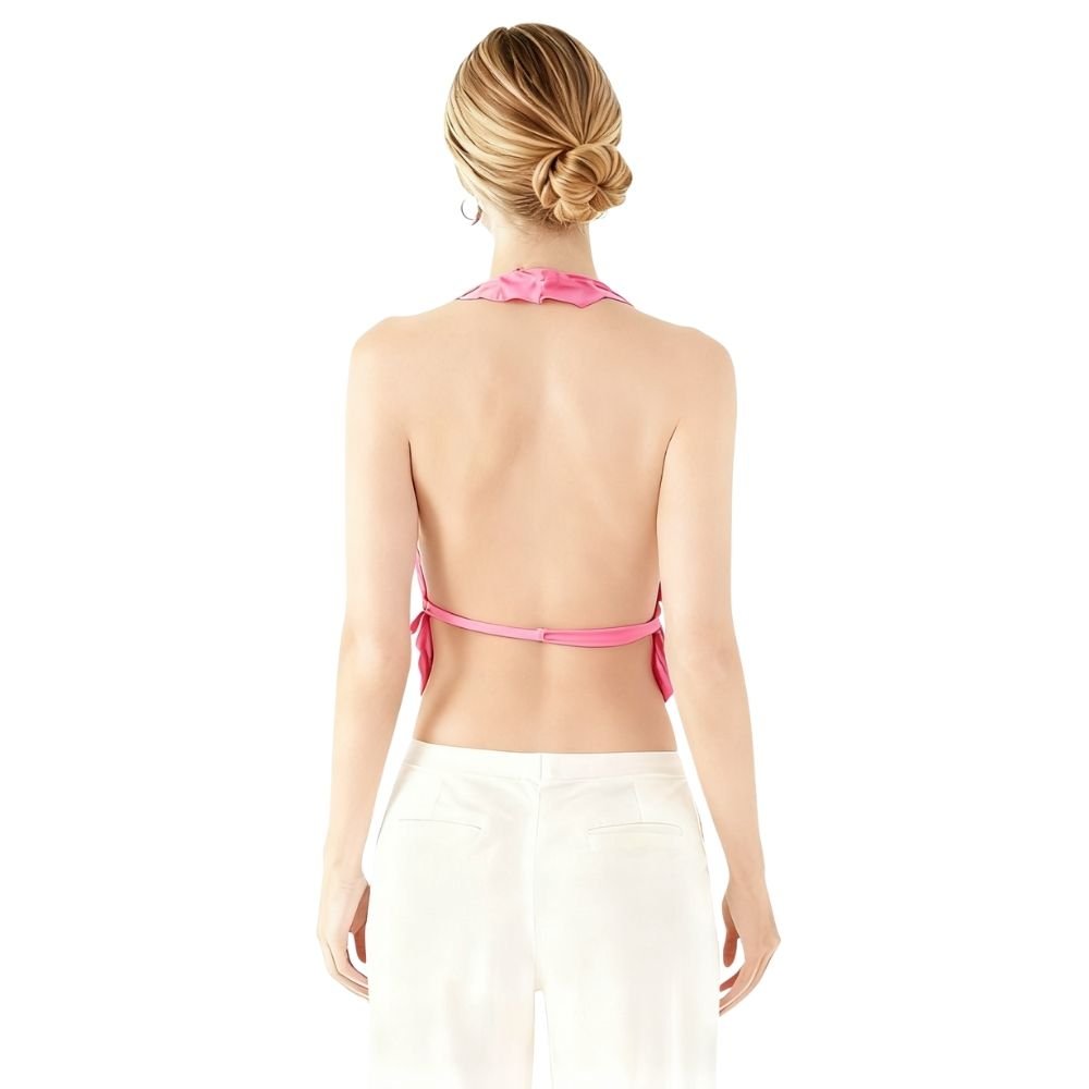 Woman wearing a pink kouvr bikini top with a white background
