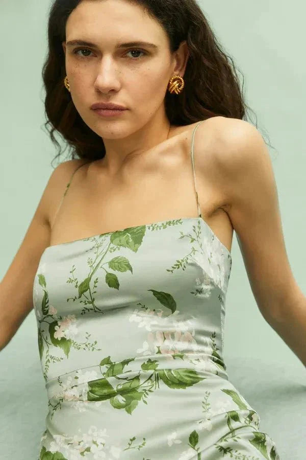 Model wearing the Kouvr Fashion Sage Green Silk Maxi Dress at an outdoor event