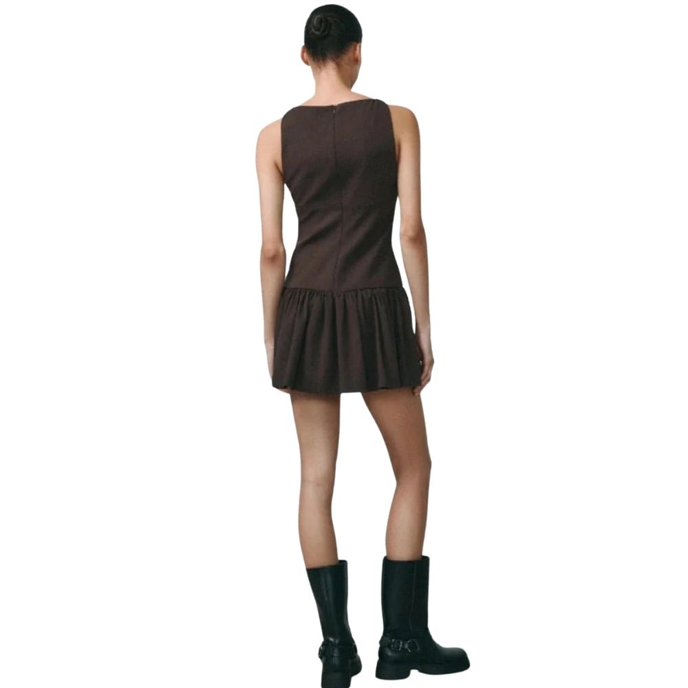 Person wearing a Brown Kouvr  dress with black boots on a white background