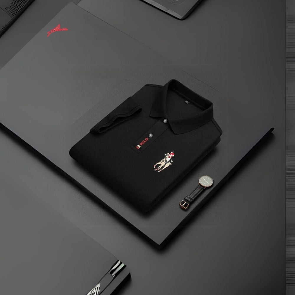 Man wearing the Kouvr Signature Black Polo Shirt with black trousers