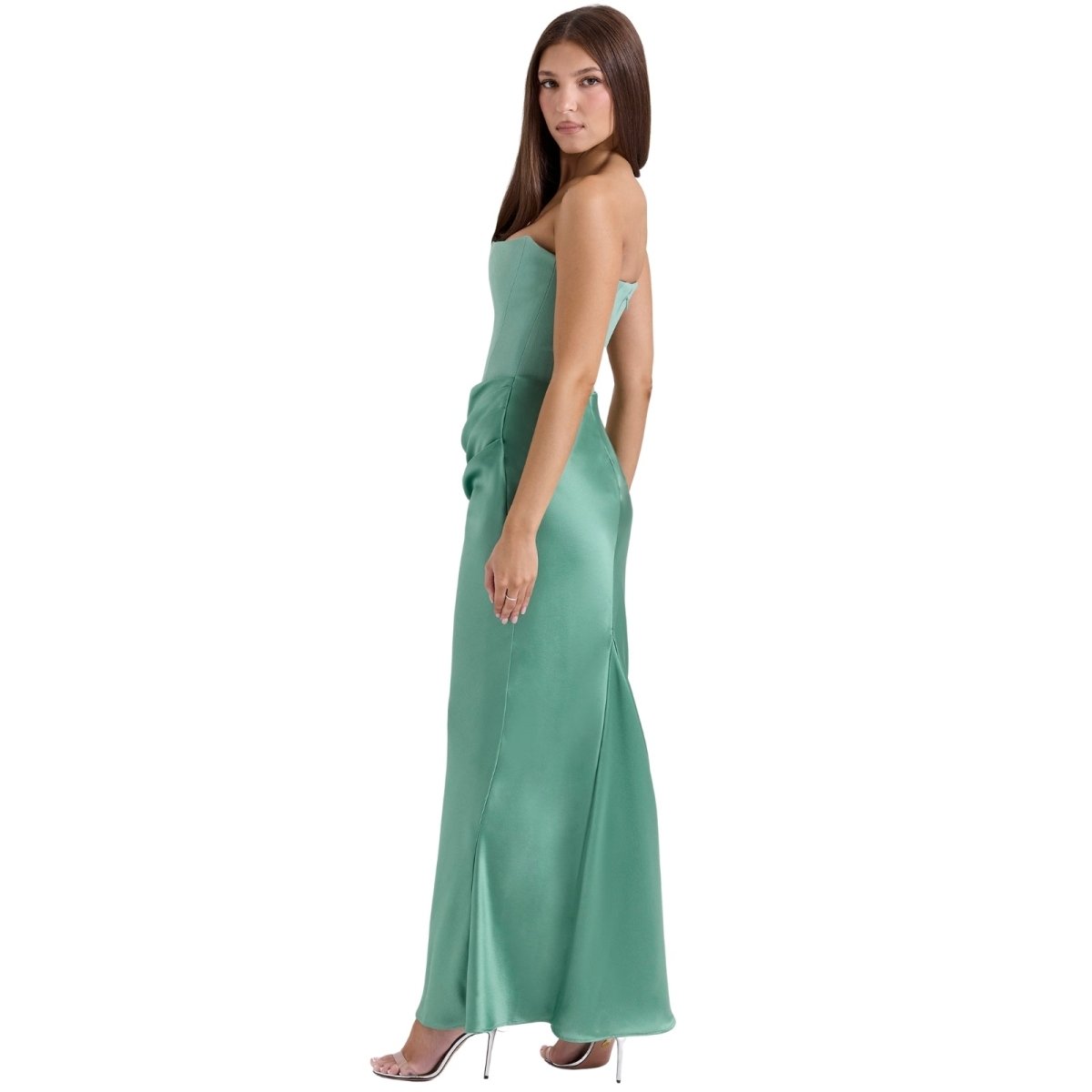 Woman wearing a green Kouvr evening gown on a white background