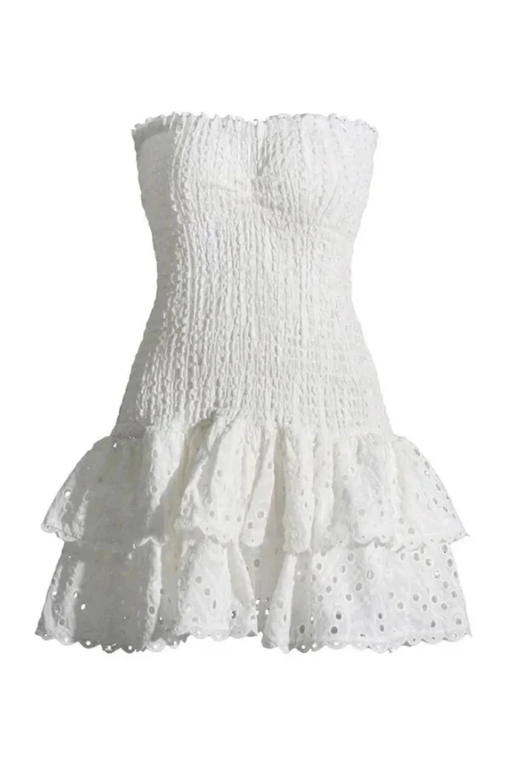 Model wearing the Kouvr Starla white strapless smocked mini dress with a tiered broderie anglaise ruffle skirt