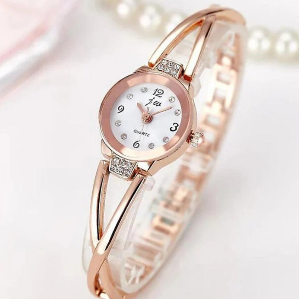 Kouvr SvelteTime women's elegant rose gold bangle watch with crystal accents.
