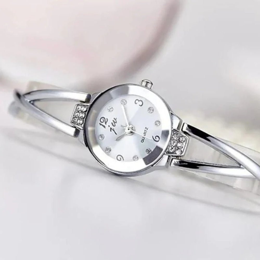 Kouvr SvelteTime women's elegant rose gold bangle watch with crystal accents.