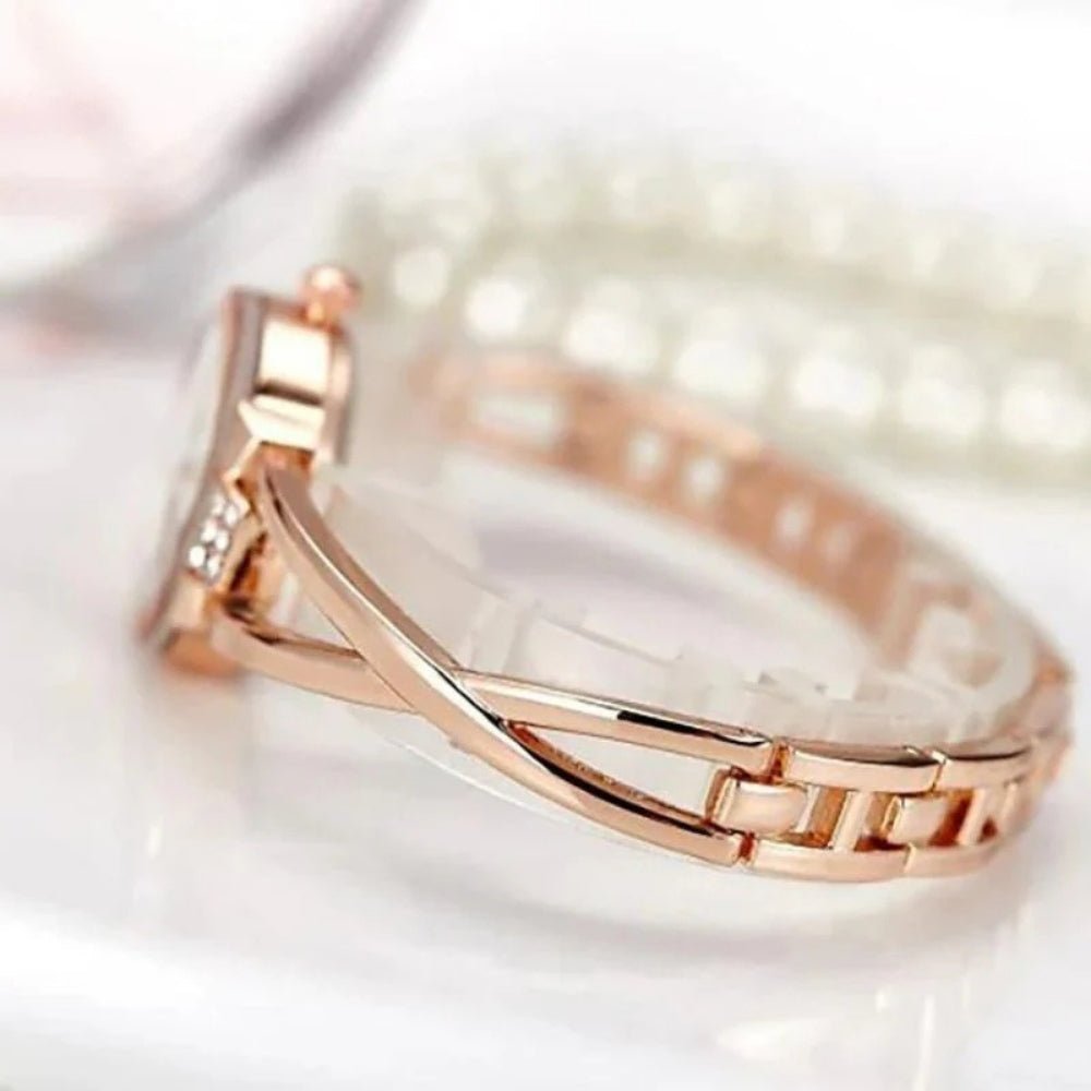 Kouvr SvelteTime women's elegant rose gold bangle watch with crystal accents.