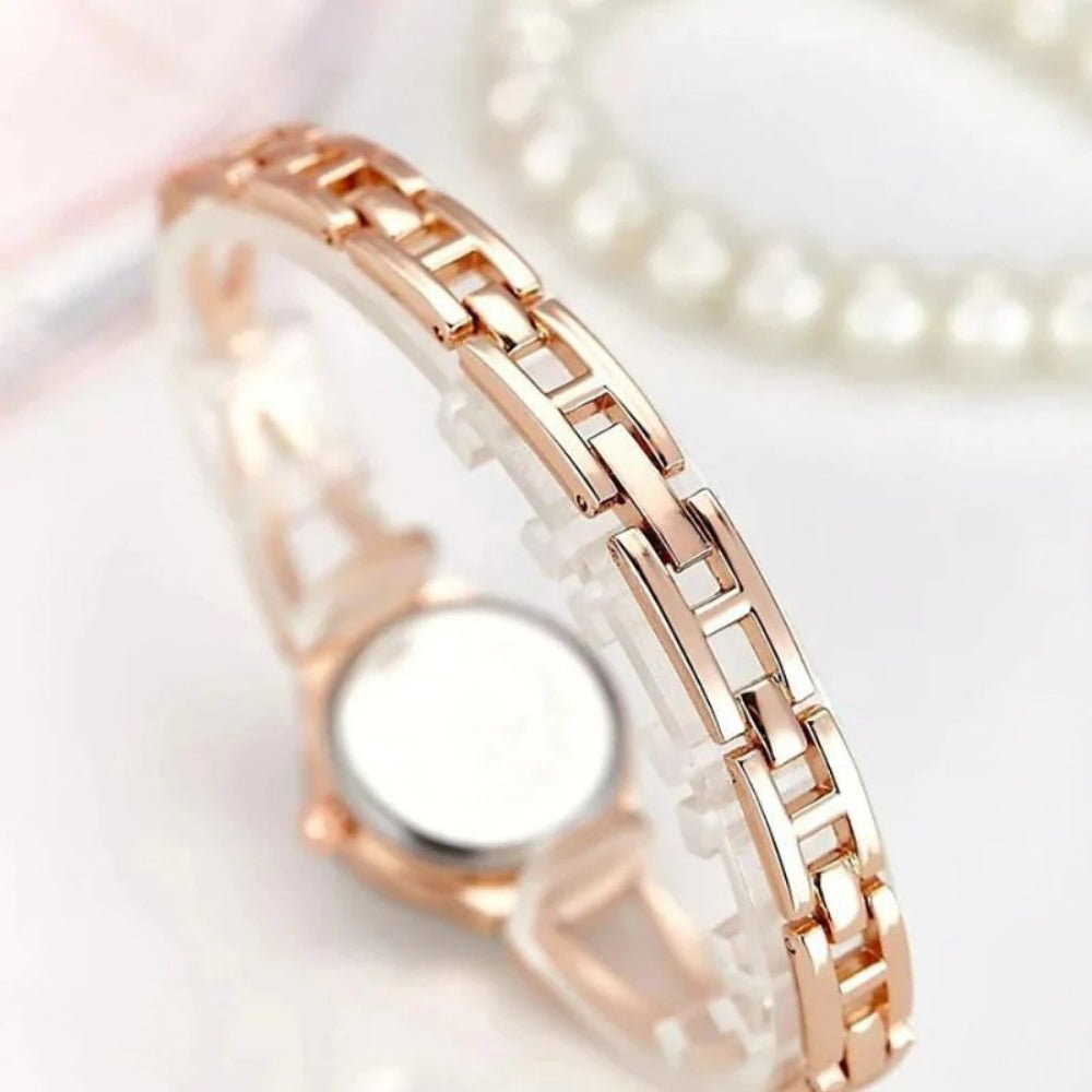 Kouvr SvelteTime women's elegant rose gold bangle watch with crystal accents.