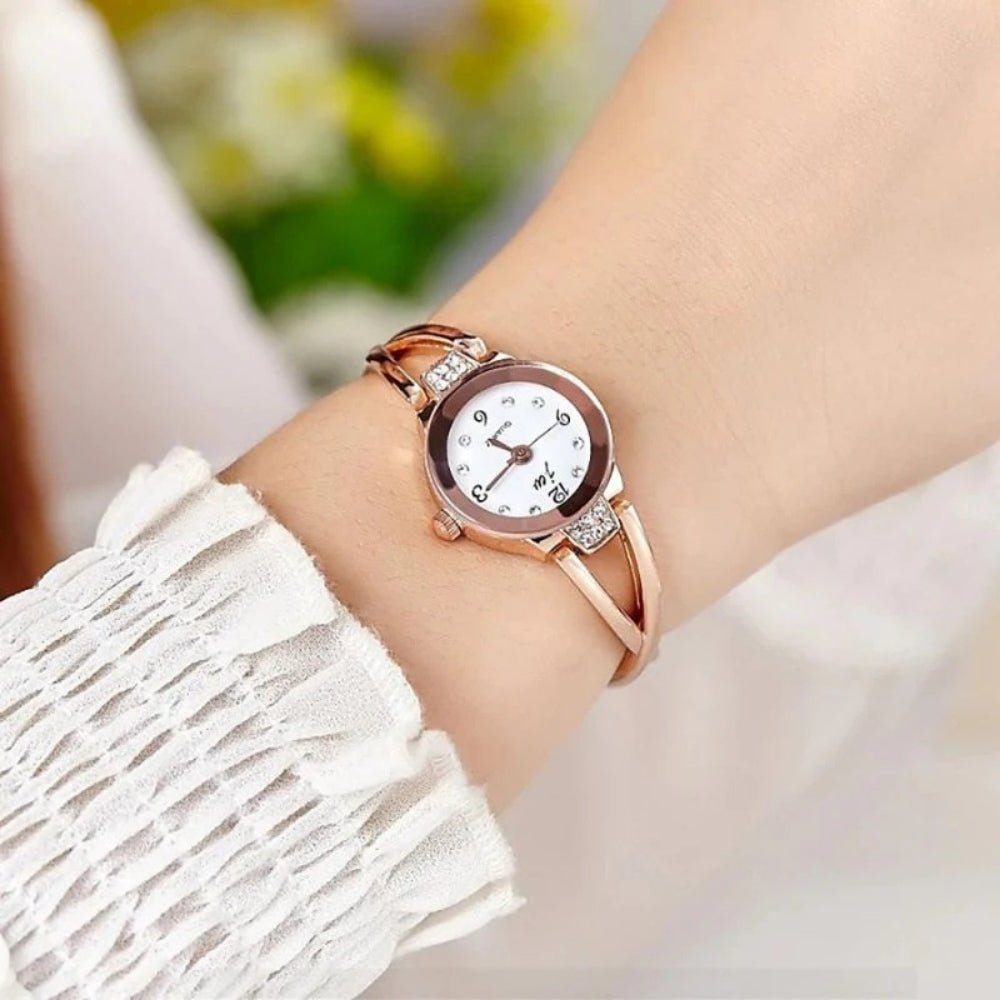Kouvr SvelteTime women's elegant rose gold bangle watch with crystal accents.