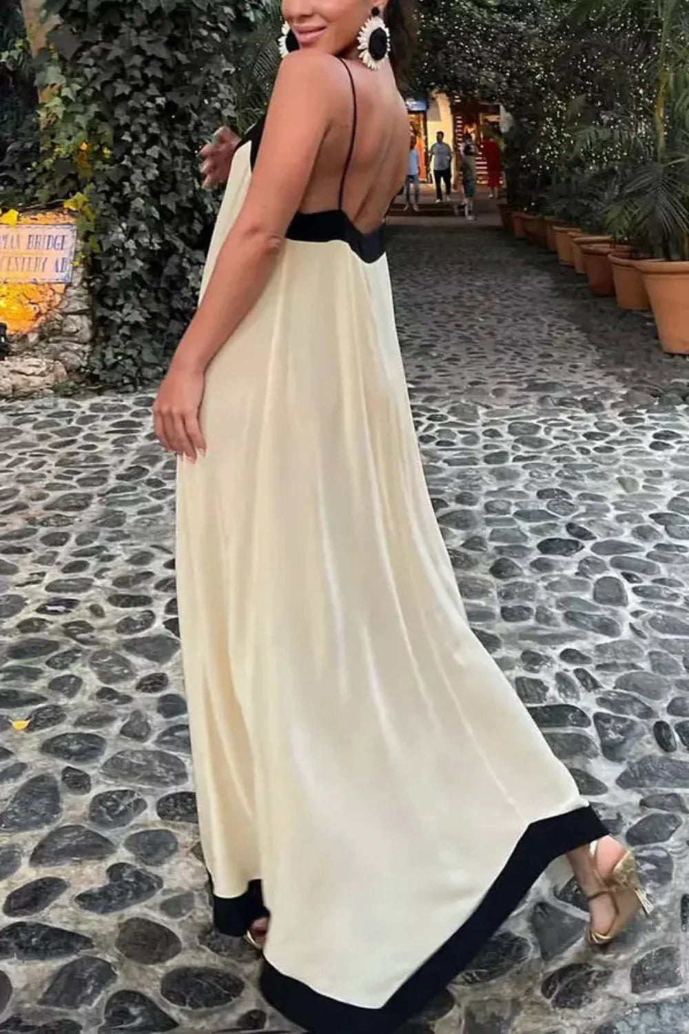 Model wearing The Dione silk maxi slip dress in white with a v-neck and low back