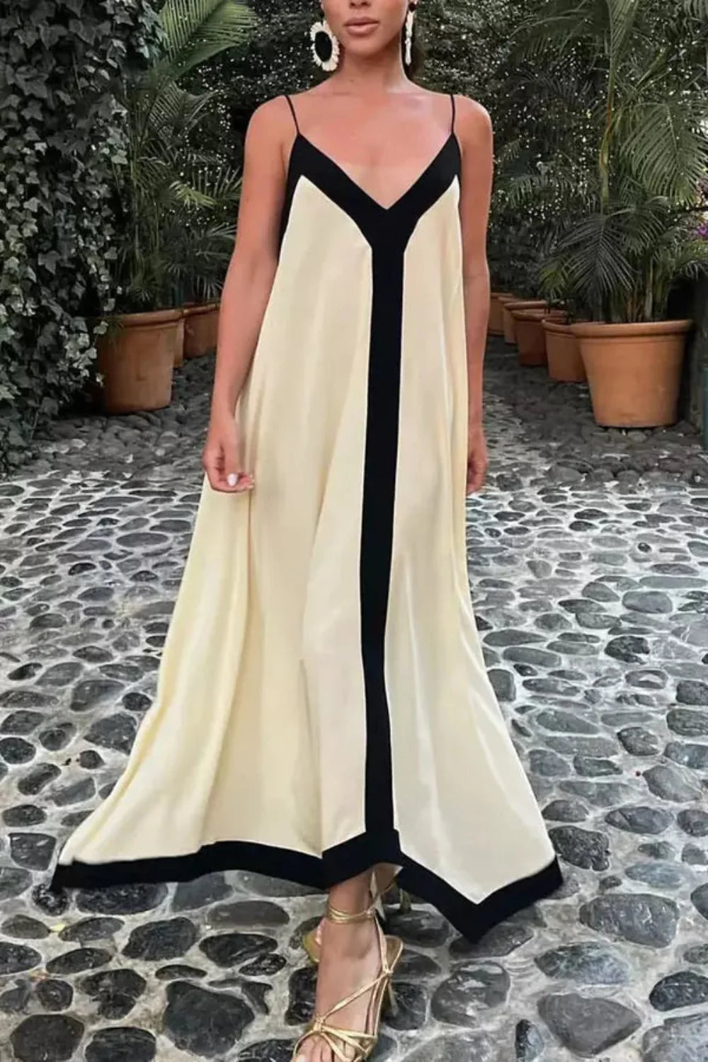 Model wearing The Dione silk maxi slip dress in white with a v-neck and low back