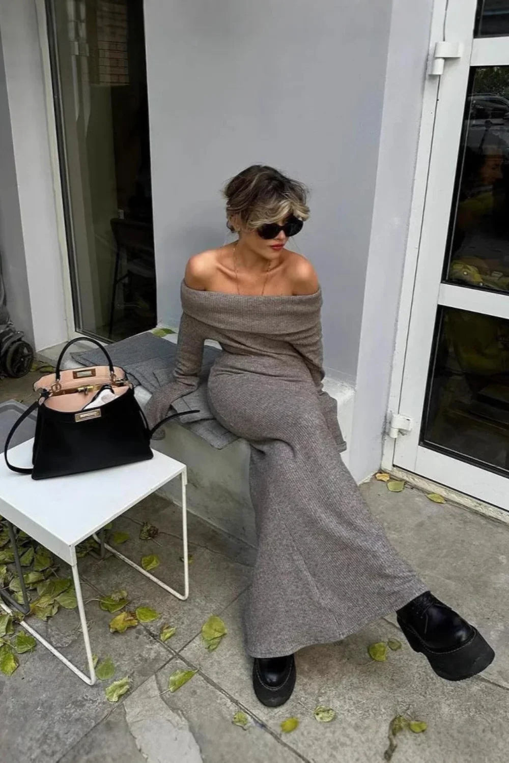 Model wearing the Kouvr Ingrid gray off-the-shoulder ribbed knit maxi dress outdoors
