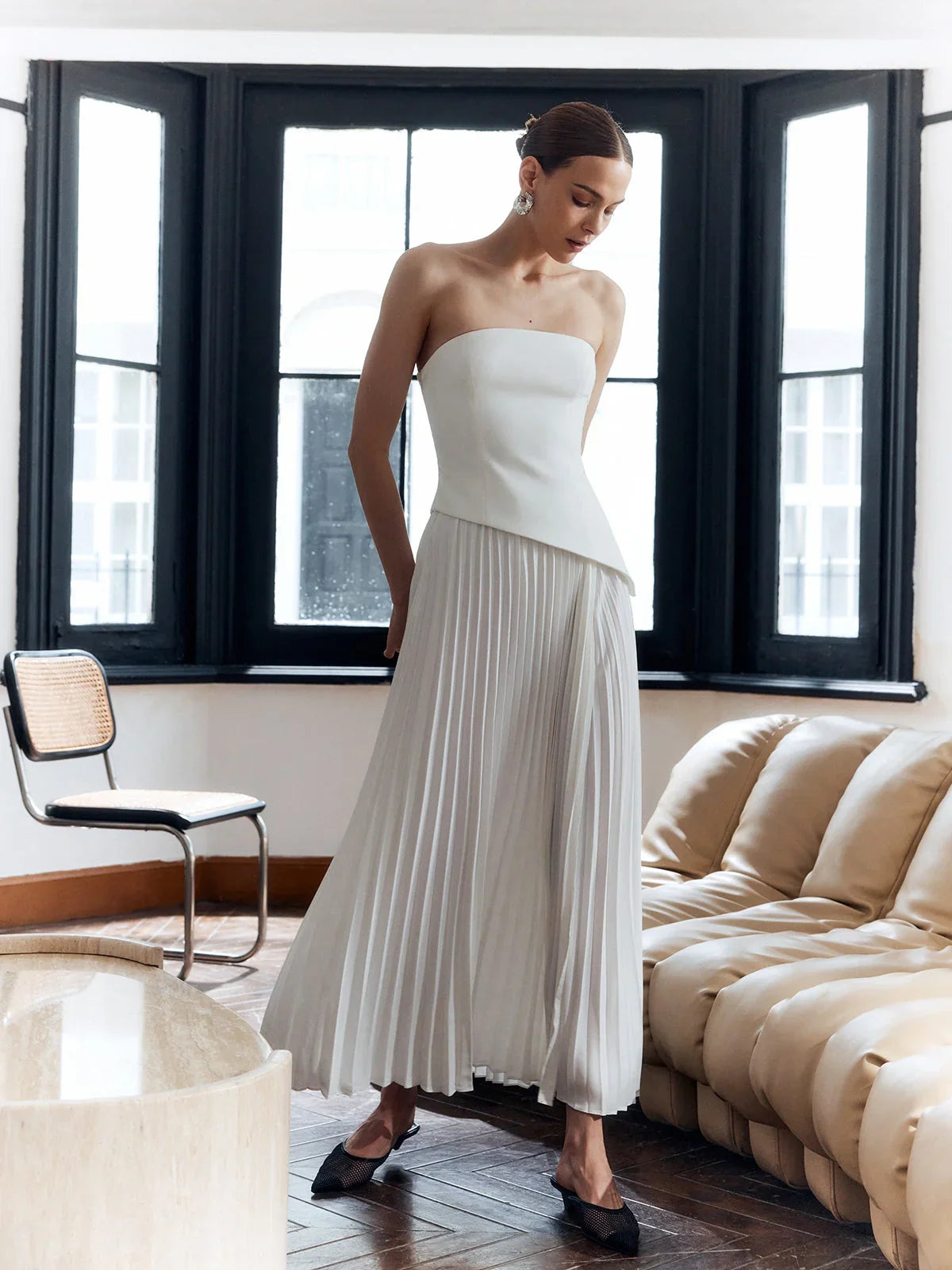 architectural," "sculptural," "asymmetrical," "bonded crepe," and "sunray pleats