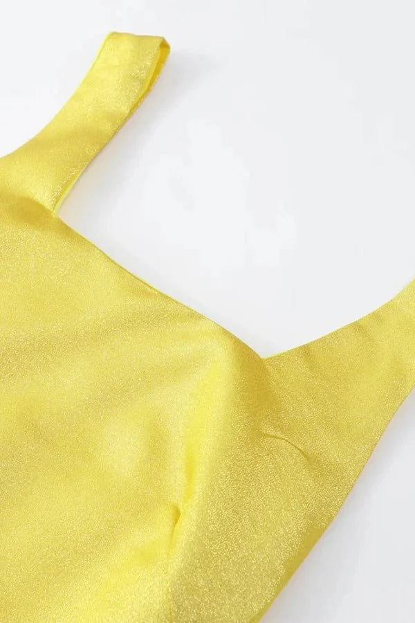 Model wearing the Kouvr Valeria canary yellow tiered ruffle maxi dress at an outdoor event