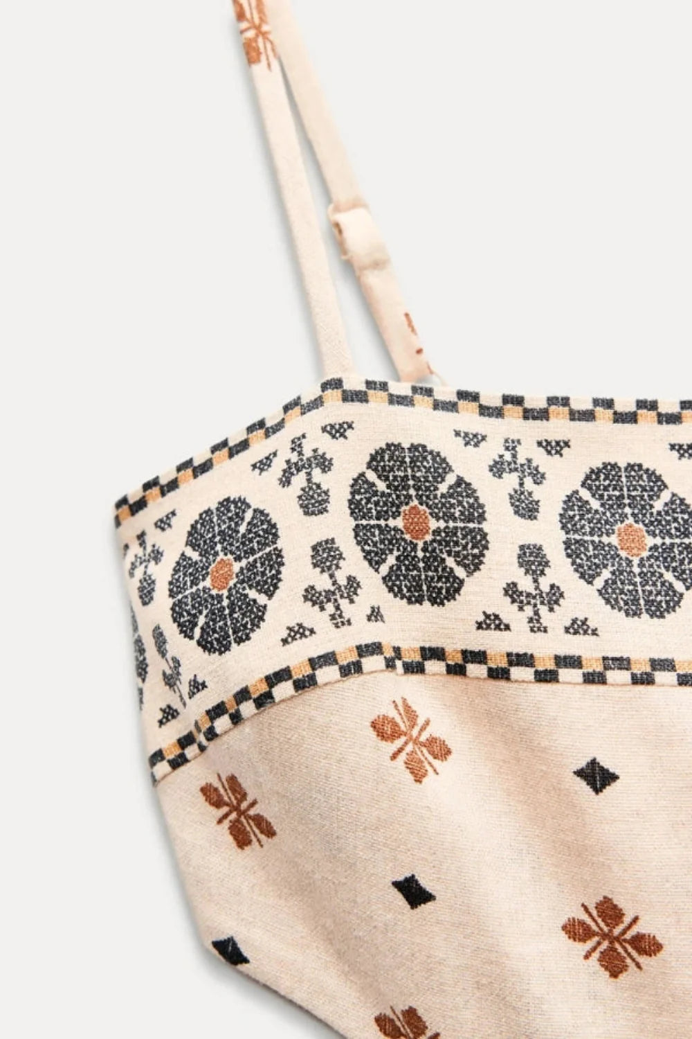 Model wearing Kouvr Vernice embroidered linen cutout midi dress sitting outdoors