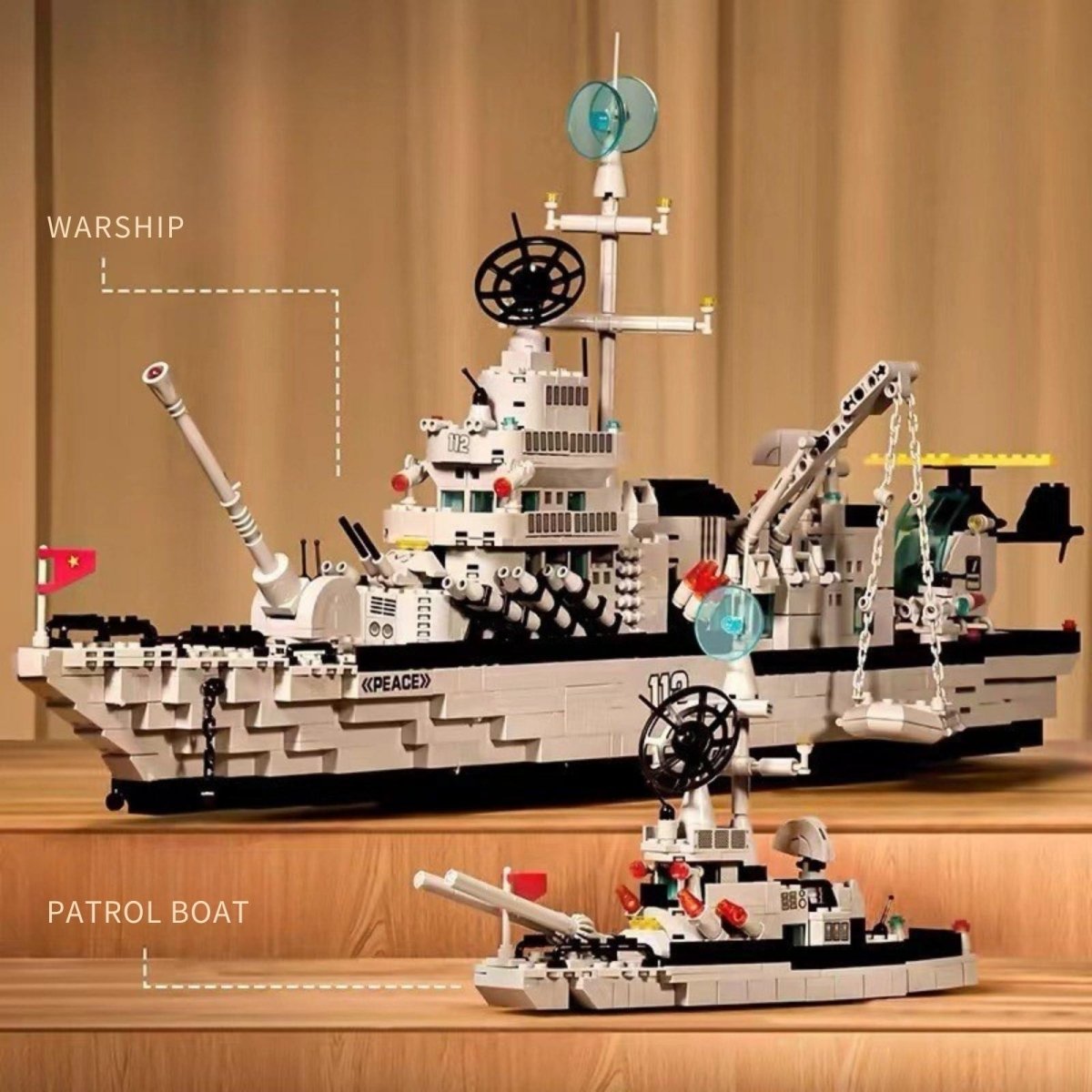 A side-by-side comparison of the large Kouvr warship building toy and the smaller patrol boat model, highlighting the scale of the set.