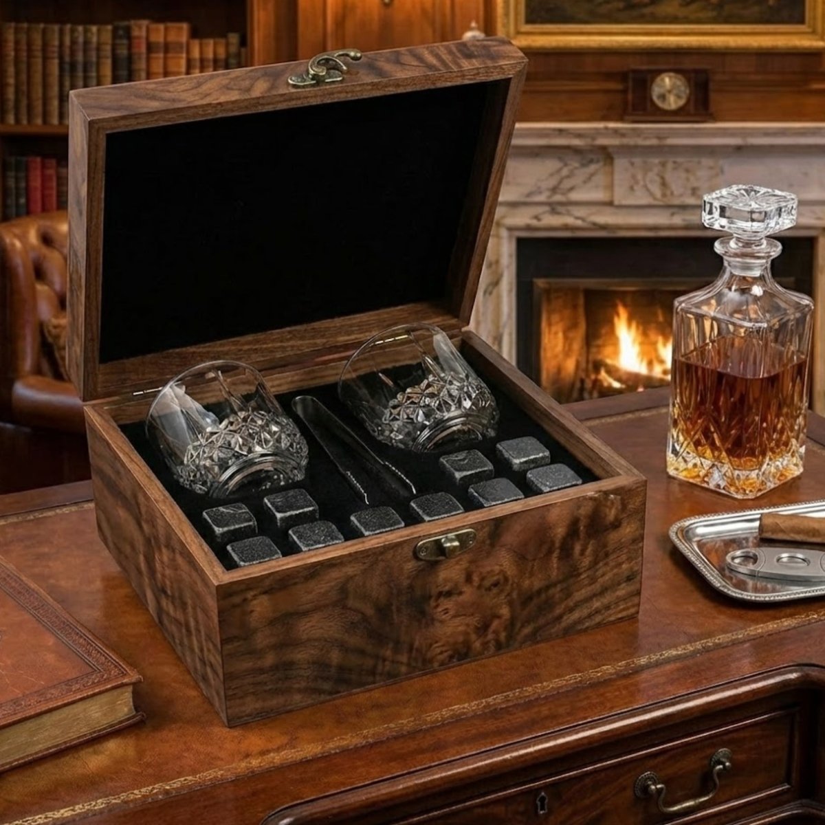 The Kouvr whiskey gift set on a leather desk next to a crystal decanter of whiskey, showcasing a luxury lifestyle setting.