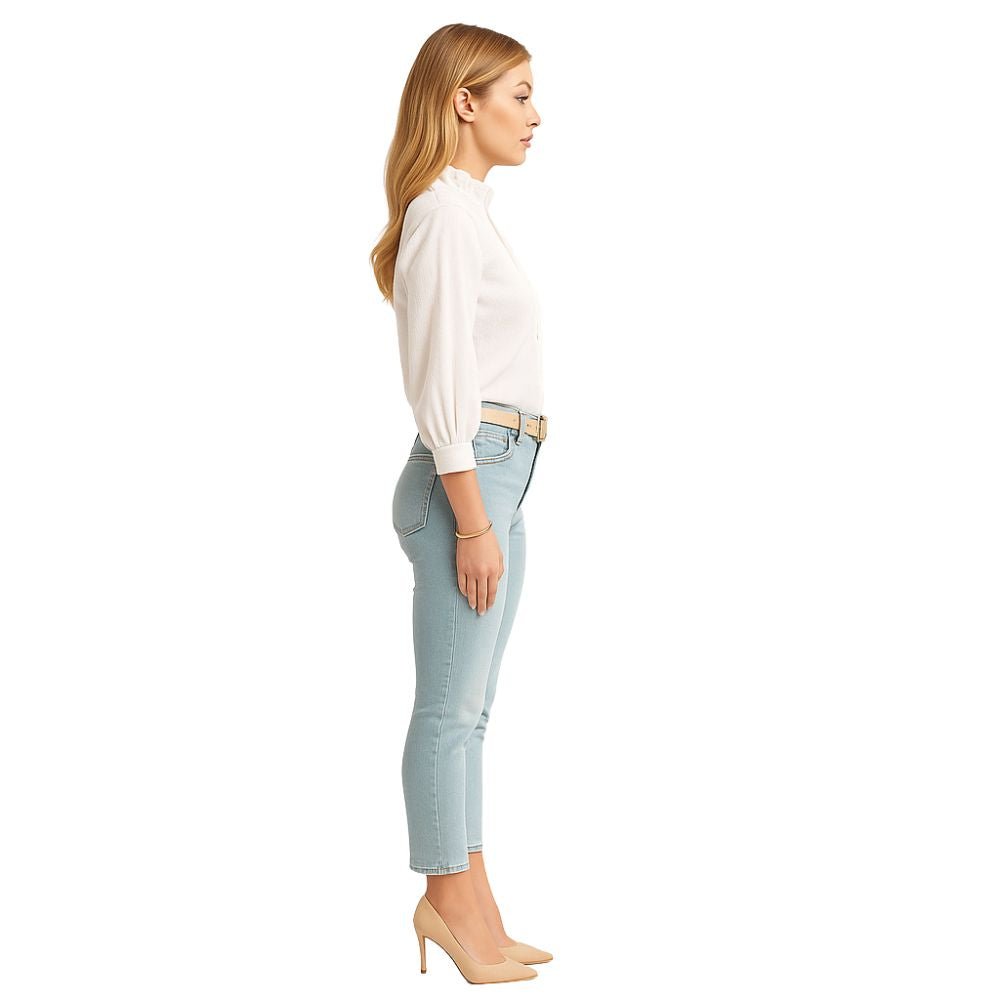 Model wearing the Kouvr Fashion Ruffle Neck Blouse, tucked into high-waisted light-wash jeans
