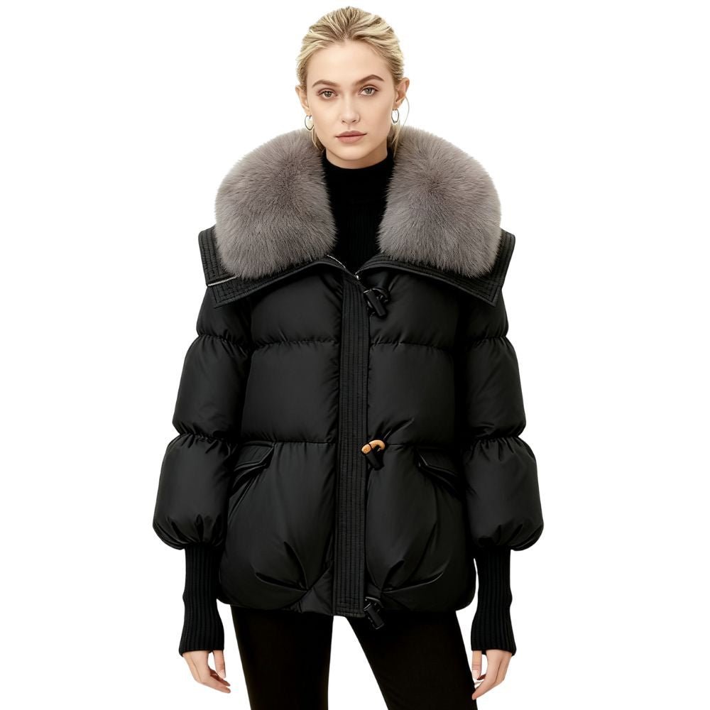 Black kouvr puffer coat with fur collar worn by a model on a white background