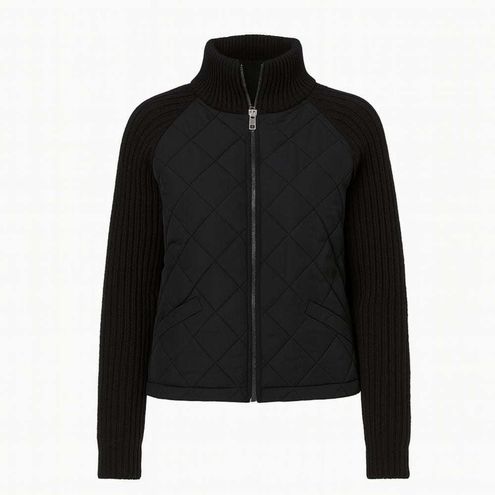 Product-only image of the black Mika hybrid jacket, zipped up, showing the full design and textures.
