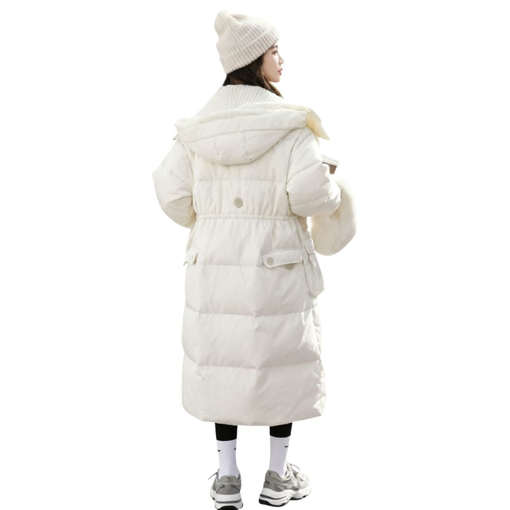 Woman wearing the Kouvr CloudWalker oversized long puffer coat in winter white