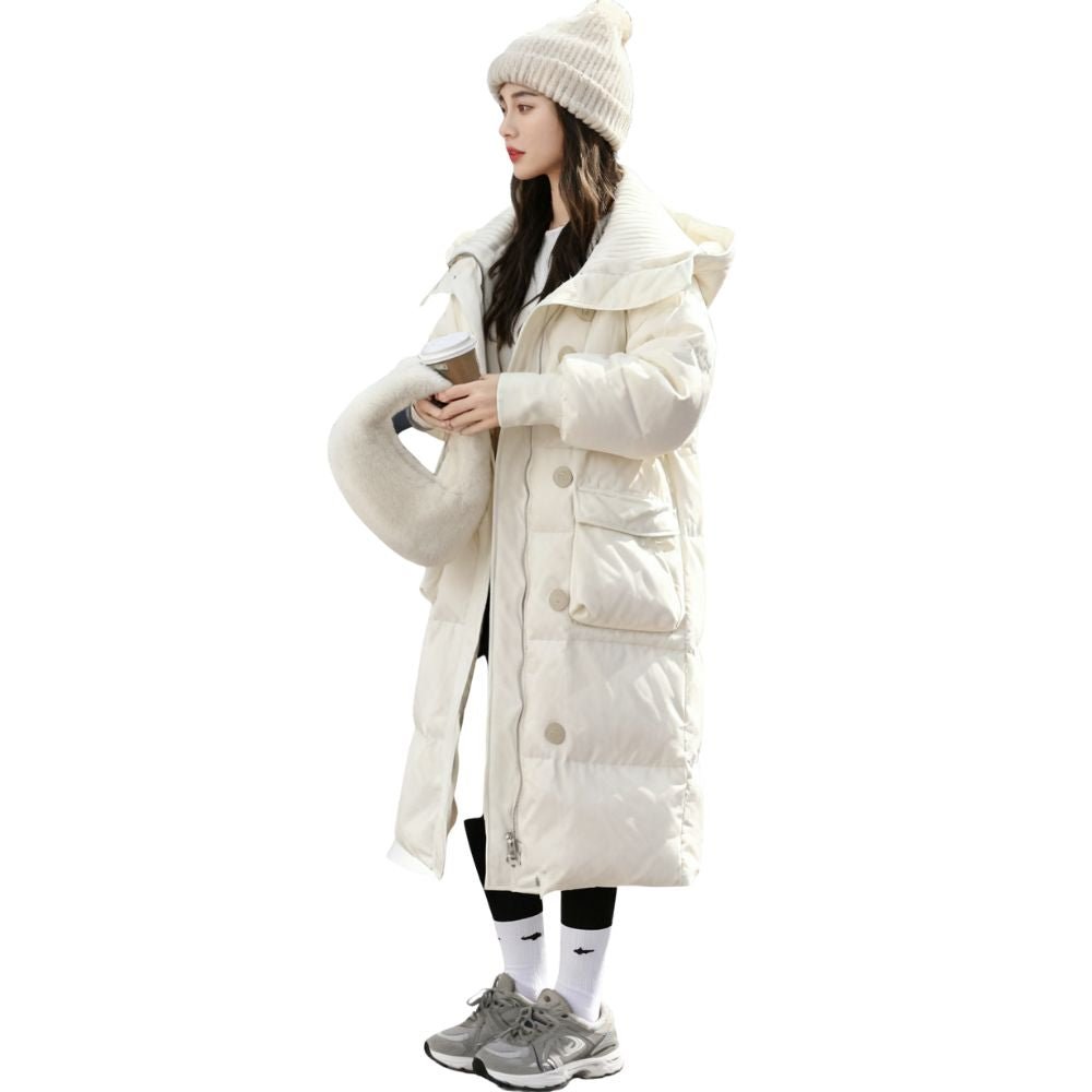 Woman wearing the Kouvr CloudWalker oversized long puffer coat in winter white