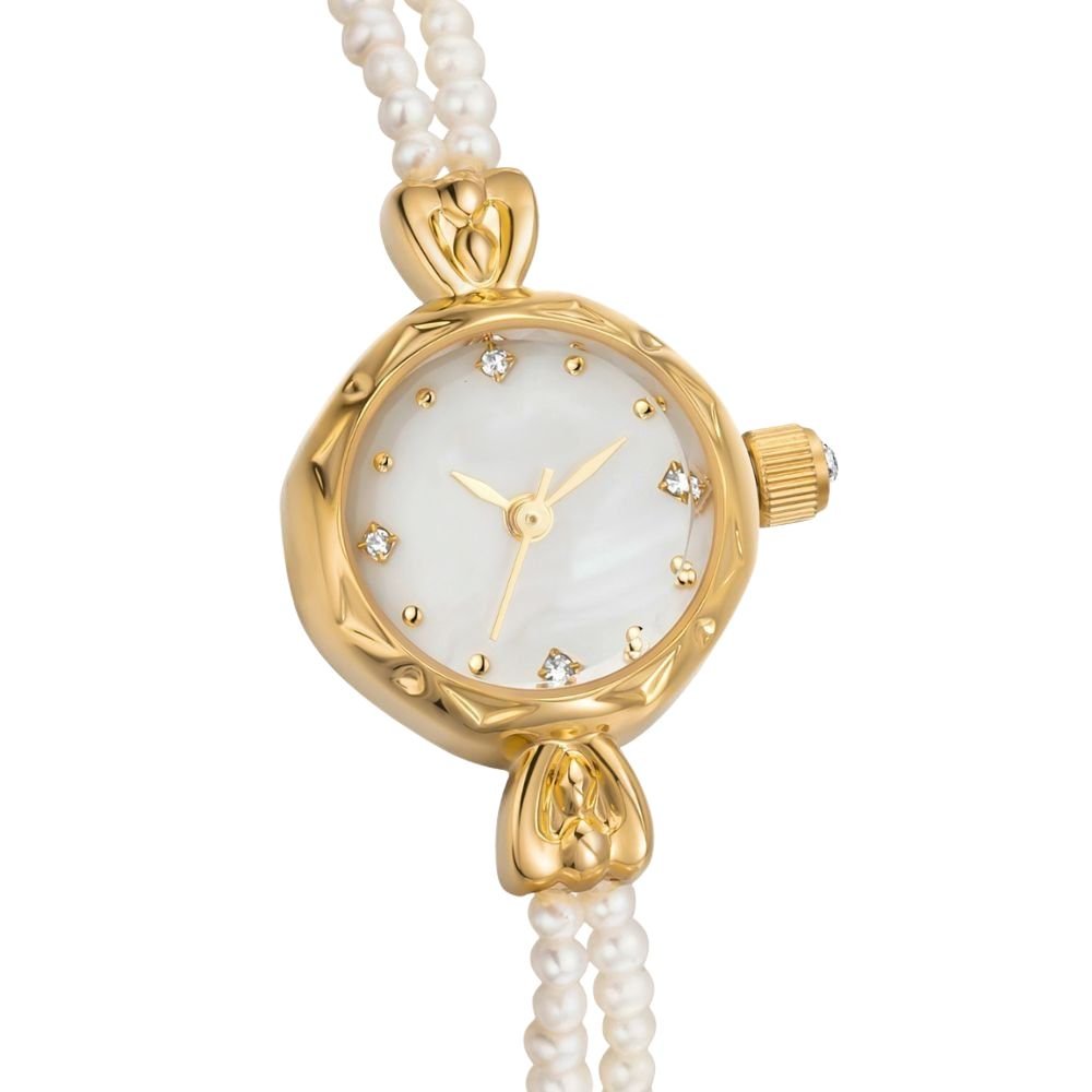 Kouvr women's elegant gold watch with a double strand real pearl bracelet and mother of pearl dial on wrist