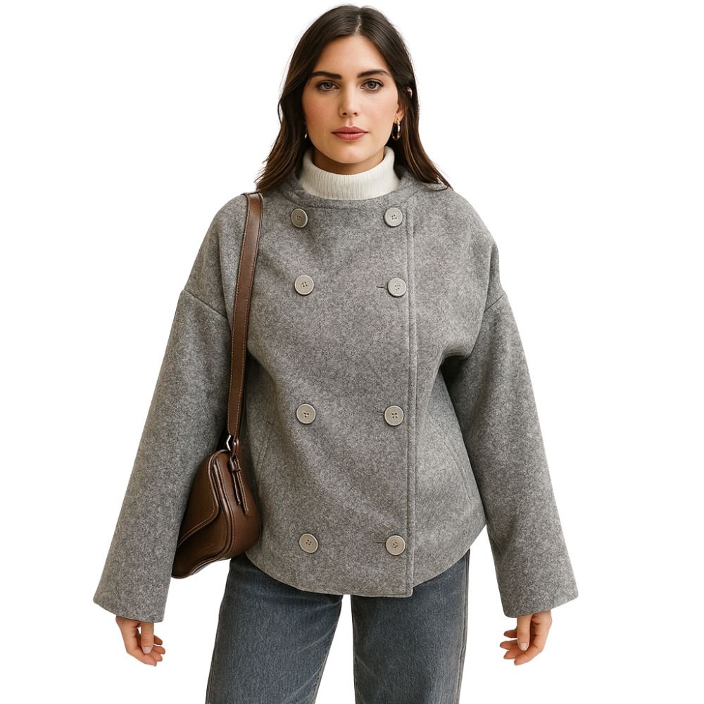 Woman wearing Kouvr's gray wool double-breasted peacoat with a white turtleneck