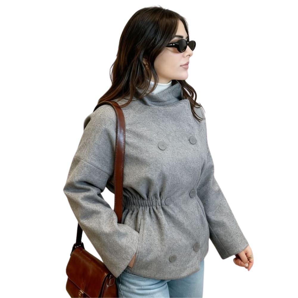 Woman wearing Kouvr's gray wool double-breasted peacoat with a white turtleneck