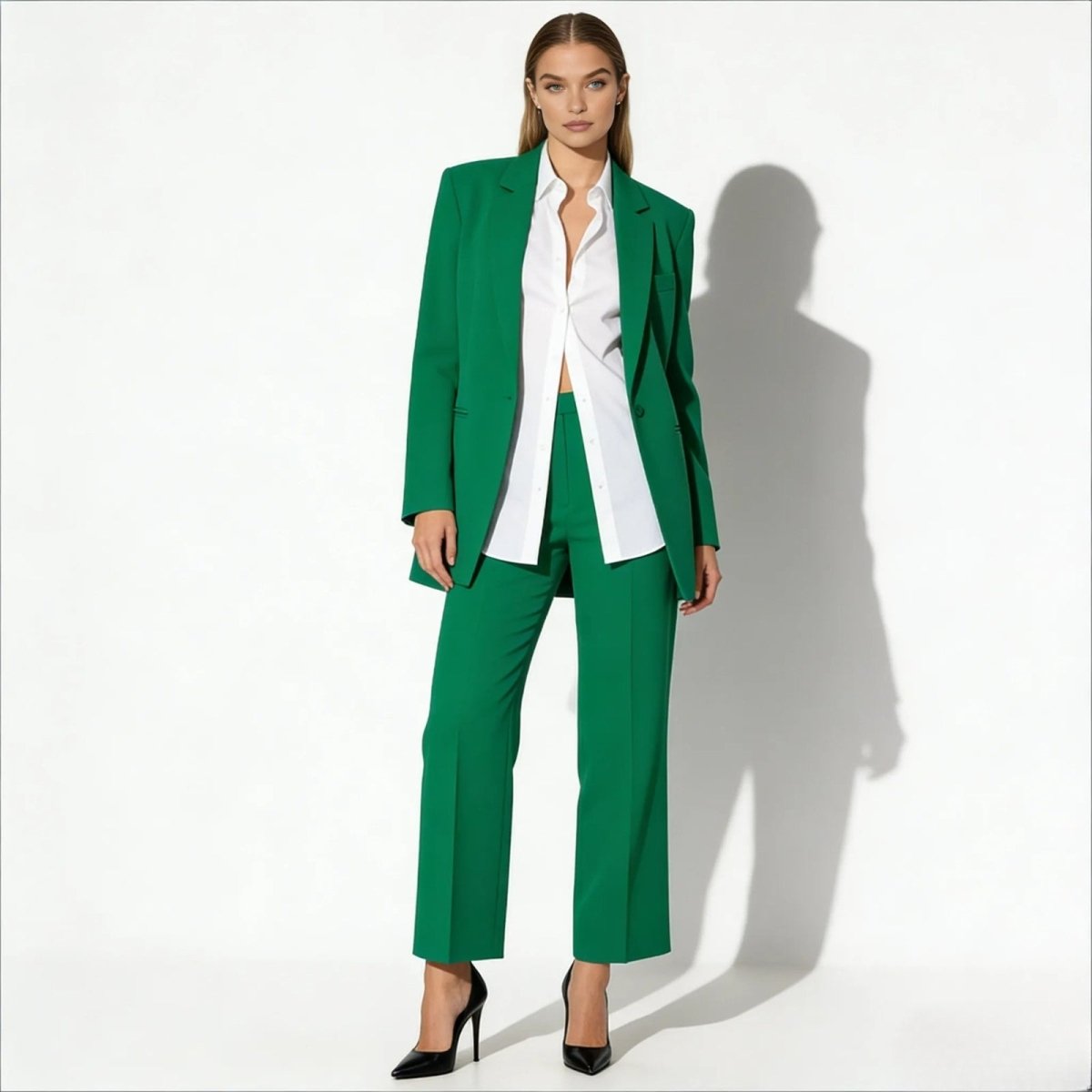 Model wearing the Kouvr kate green oversized blazer and matching wide-leg trousers, styled with a white shirt and black heels against a white background.
