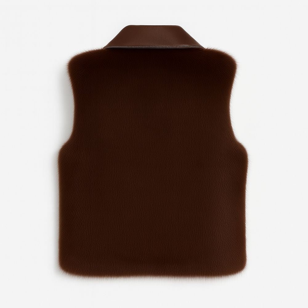 A model wears the Kouvr women's sable mink fur and Nappa leather vest in dark brown, paired with blue jeans.