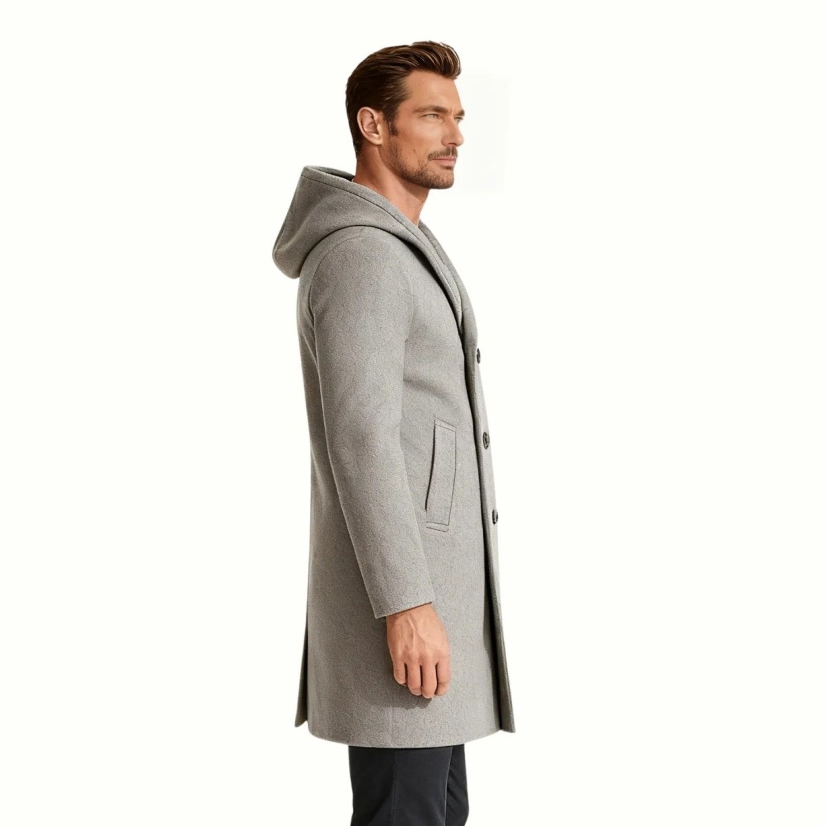 Side profile of a model in the Kouvr Xander men's grey double-breasted winter overcoat, highlighting its mid-length and slim silhouette.