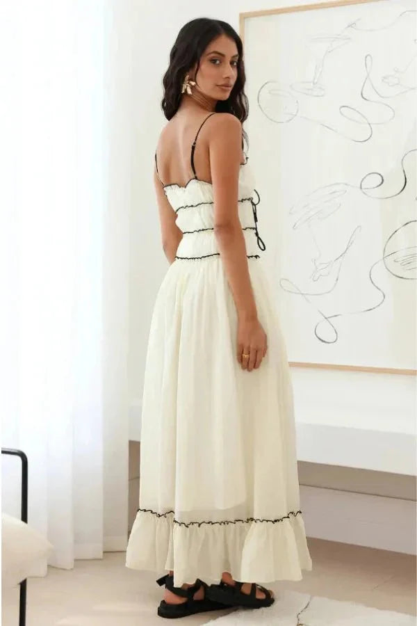 Model wearing the Kouvr Yoona white cotton maxi dress with black corset ties