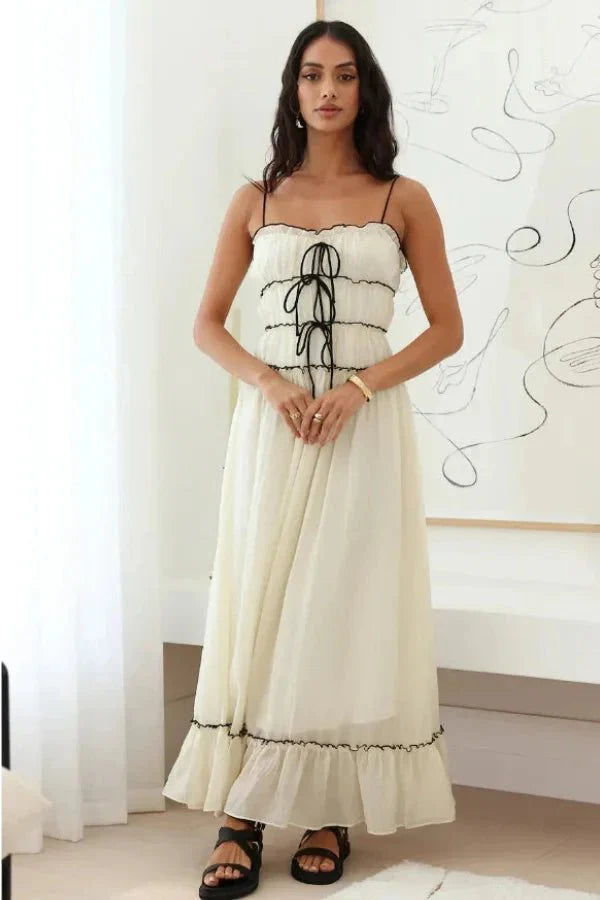 Model wearing the Kouvr Yoona white cotton maxi dress with black corset ties