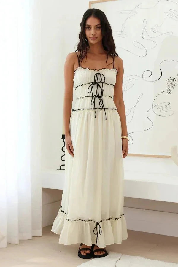 Model wearing the Kouvr Yoona white cotton maxi dress with black corset ties