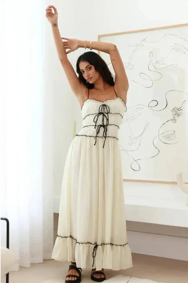 Model wearing the Kouvr Yoona white cotton maxi dress with black corset ties