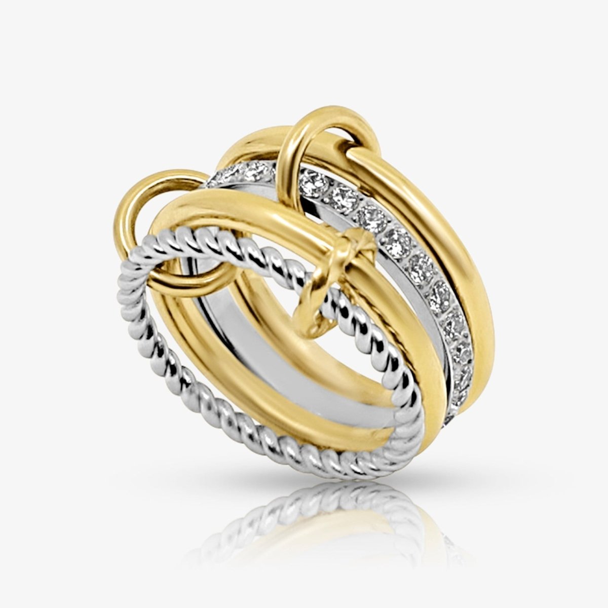 Two gold and silver kouvr rings with diamond accents on a white background