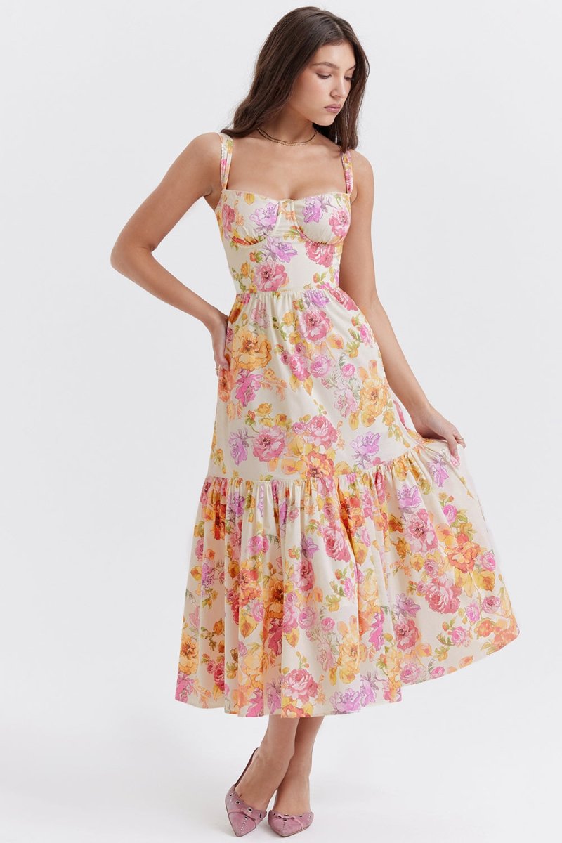 Side profile of a woman in The Persephone floral bustier midi dress, highlighting the A-line silhouette and tiered hem.